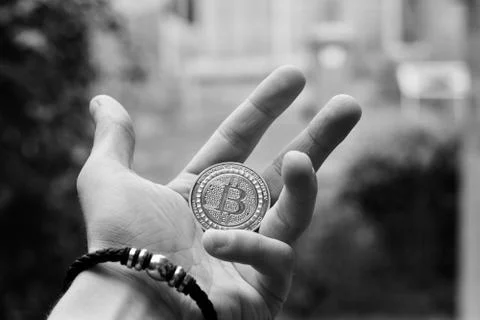 Bitcoin coin in hand Stock Photos