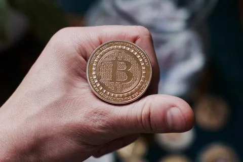 Bitcoin coin in hand Stock Photos