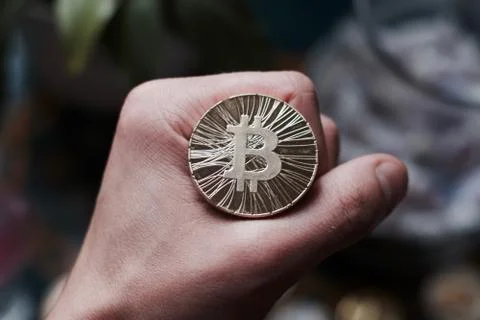 Bitcoin coin in hand Stock Photos