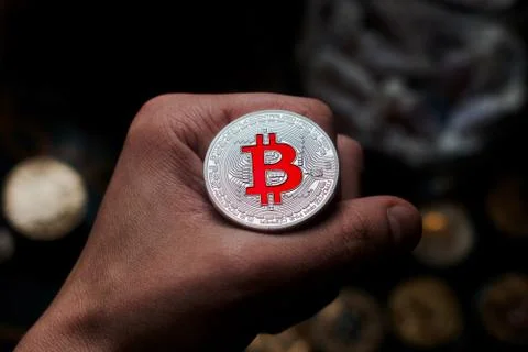Bitcoin coin in hand Stock Photos