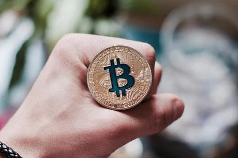 Bitcoin coin in hand Stock Photos