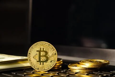 Bitcoin coin on keyboard computer with black background Stock Photos