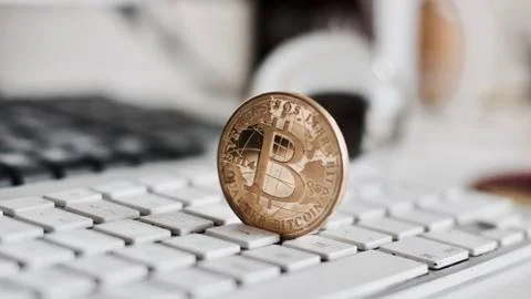 Bitcoin coin on the keyboard Stock Photos