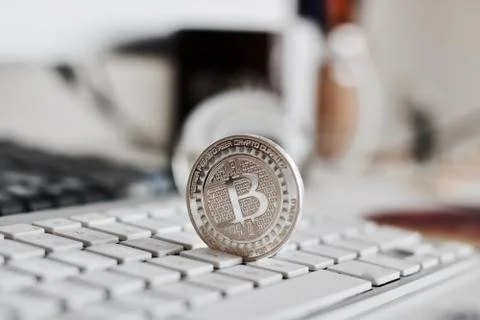 Bitcoin coin on the keyboard Stock Photos