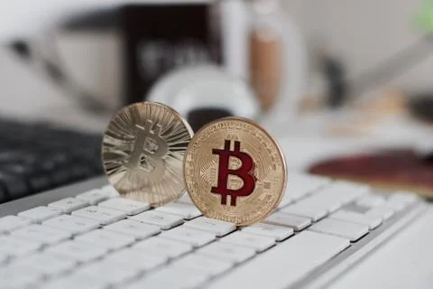 Bitcoin coin on the keyboard Stock Photos