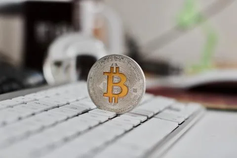 Bitcoin coin on the keyboard Stock Photos