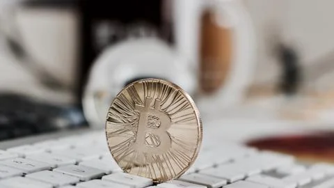 Bitcoin coin on the keyboard Stock Photos
