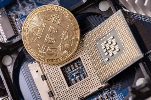 Bitcoin is a coin, on the processor socket. Crypto currency. Stock Photos