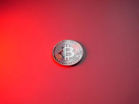 Bitcoin coin on red background. Cryptocurrency mining Stock Photos