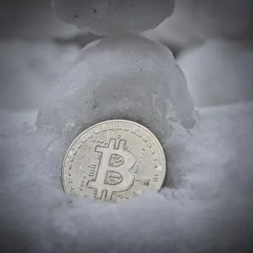 Bitcoin coin in snow Stock Photos