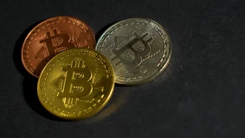 Bitcoin coins on a black background, close-up. Stock Footage 257571591
