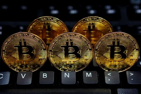 Bitcoin coins on computer keyboard Stock Photos
