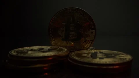 Bitcoin coins on isolated black surface. Gold light reflect on it. world crypto Stock Footage 142311318
