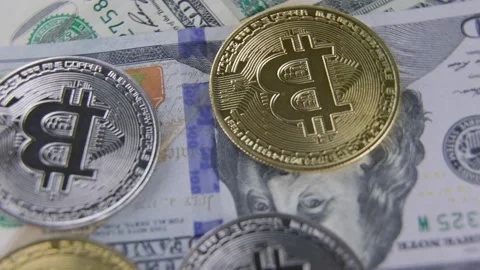 Bitcoin coins lie on dollars Stock Footage 170383752