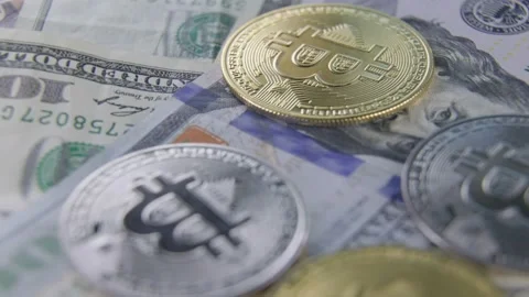 Bitcoin coins lie on dollars Stock Footage 170887708