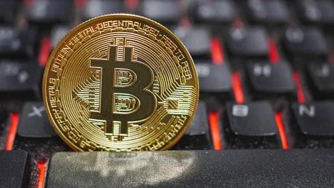 Bitcoin On Computer Keyboard In Background Stock Photos