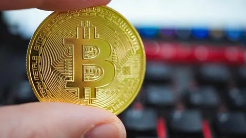 Bitcoin On Computer Keyboard In Background Stock Photos