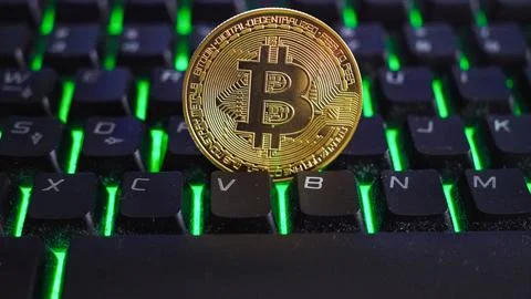 Bitcoin on computer keyboard in background, symbol of electronic virtual money Stock Photos