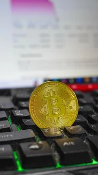 Bitcoin on computer keyboard in background, symbol of electronic virtual money Stock Photos