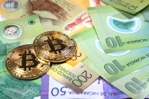 Bitcoin concept on brightly colored background of foreign currency Stock Photos