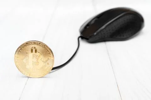 Bitcoin connected with computer mouse Stock Photos