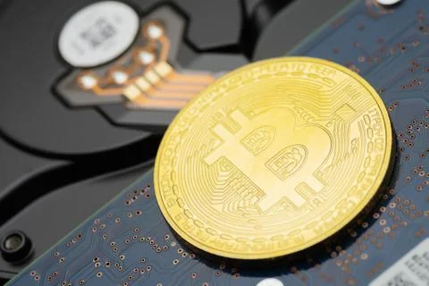 Bitcoin criptocurrency coin on hard disk drive Stock Photos