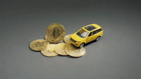 The bitcoin crypto coin on a grey board with yellow car, macro Stock-Footage 264072172