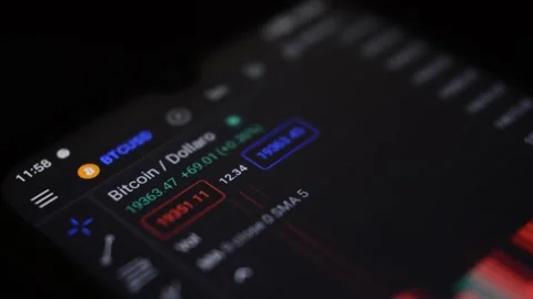 Bitcoin crypto currency trading chart on the phone of a businessman Video stock 200140282