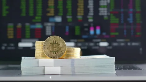 Bitcoin cryptocurrency and dollar banknotes over stock market chart Video stock 147314813