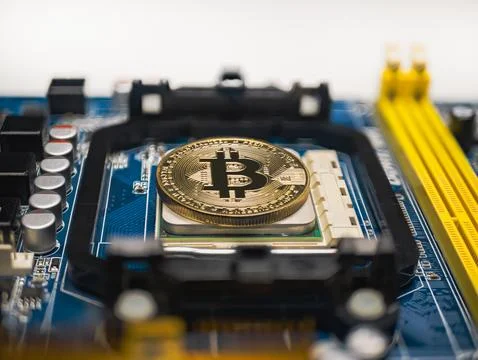 Bitcoin cryptocurrency coin among electronics as digital money Foto stock