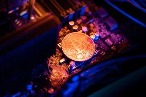 Bitcoin Cryptocurrency coin on a PC computer motherboard, crypto currency min Stock Photos