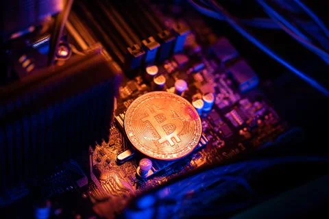 Bitcoin Cryptocurrency coin on a PC computer motherboard, crypto currency min Stock Photos