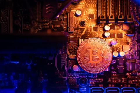 Bitcoin Cryptocurrency coin on a PC computer motherboard, crypto currency min Stock Photos