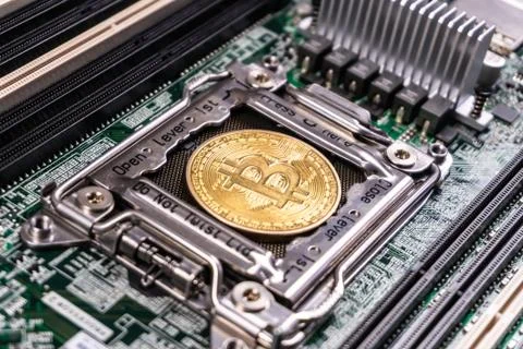 Bitcoin Cryptocurrency on computer circuit board Stock Photos