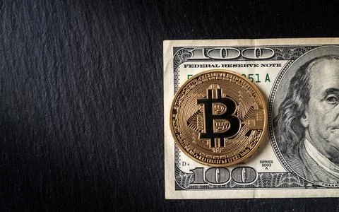 Bitcoin cryptocurrency equivalent to dollar, a banknote of one hundred units Stock Photos