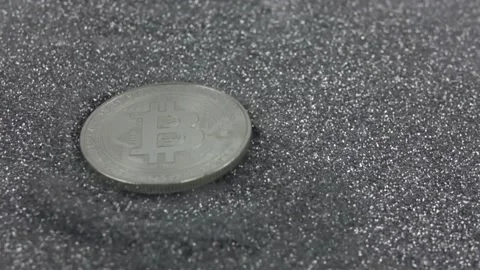 Bitcoin cryptocurrency falls on silver sequins. Stock Footage 155544149