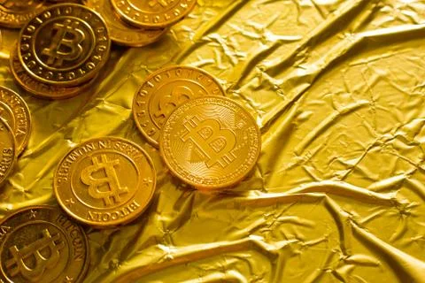 The Bitcoin cryptocurrency in gold texture  image background. Stock Photos