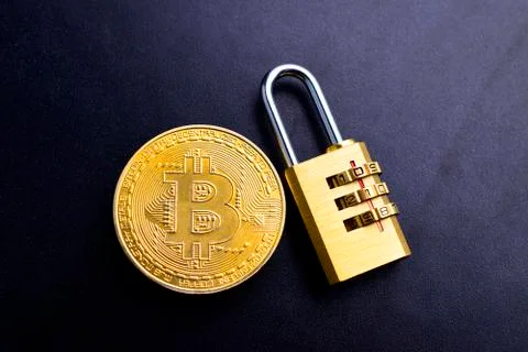 A Bitcoin Cryptocurrency with lock on black texture background with text spac Stock Photos