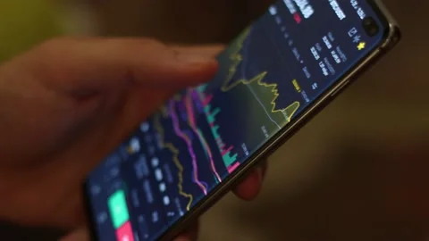 Bitcoin cryptocurrency price chart on digital exchange on mobile phone Stock Footage 157192192