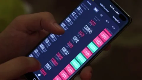 Bitcoin cryptocurrency price chart on digital exchange on mobile phone Stock Footage 157192236