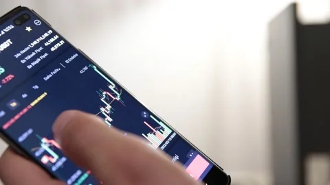 Bitcoin cryptocurrency price chart on digital exchange on mobile phone screen Stock Footage 171217696