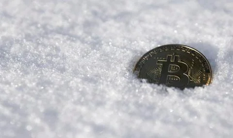 Bitcoin. Cryptocurrency on snow, in the background. The concept of freelancing Stock Photos