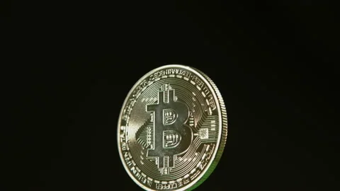 Bitcoin cryptocurrency spinning on black background pt 6 of 12 Stock Footage 149708080