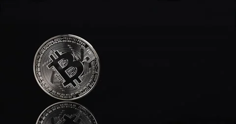 Bitcoin cryptocurrency spinning on black background with reflection Stock Footage 231574885