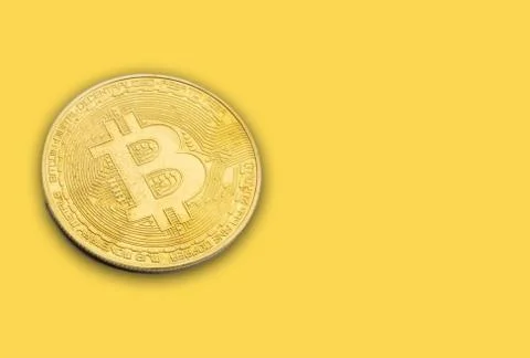 BITCOIN Cryptocurrency on yellow background Stock Photos