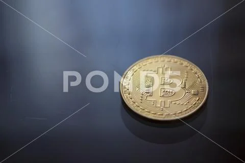 Bitcoin curency DOF on blue light background Stock Photos