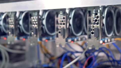 Bitcoin currency mining concept. Lots of bitcoin miners set up on shelfs. 4K. Stock Footage 94811756