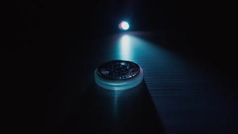 Bitcoin on a dark background is illuminated with a contrasting light and scanned Stock Footage 168468840