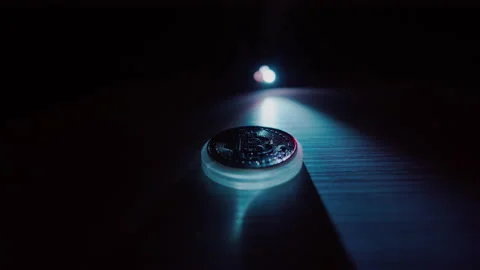 Bitcoin on a dark background is illuminated with a contrasting light and scanned Stock-Footage 168469064