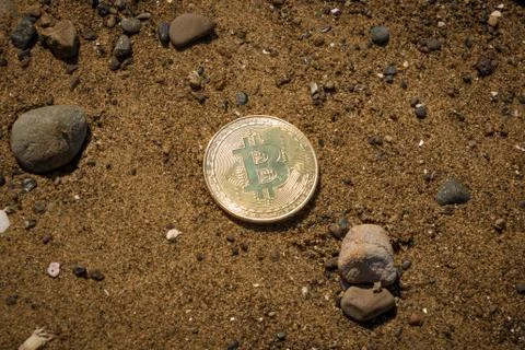 Bitcoin On Dark Sand Stock Photos